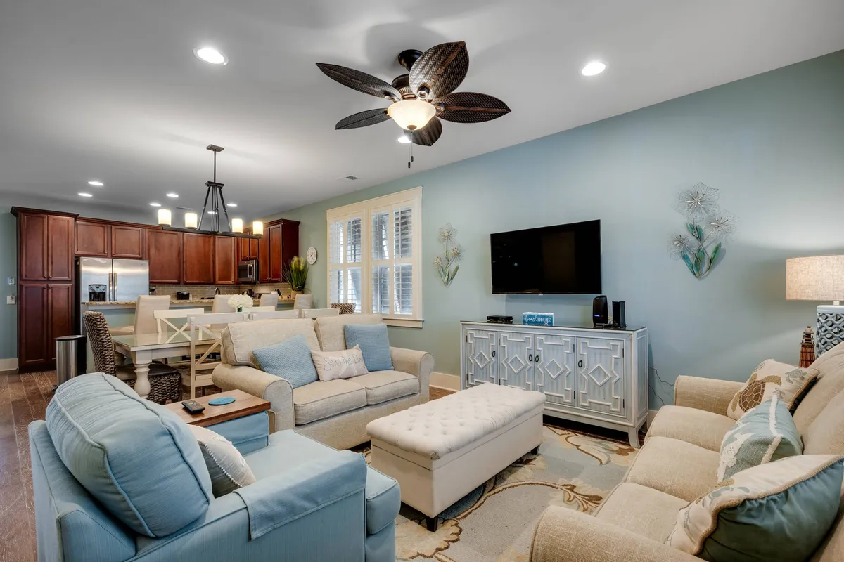 A cozy seating area with a large flat-screen TV, plush seating, and decorative wall art. This space is designed for family gatherings, movie nights, and relaxed group interactions, making it easily adaptable for entertainment.