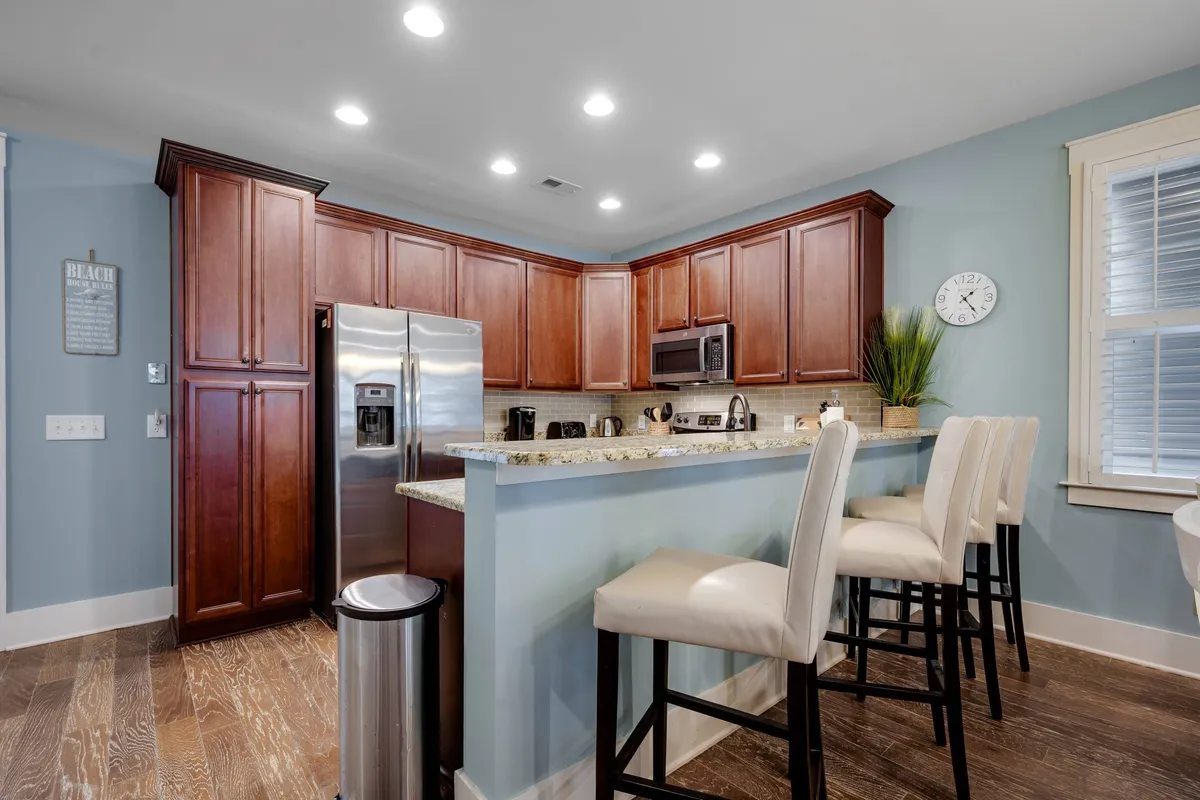 A view of the kitchen island, highlighting gleaming granite countertops, stainless steel appliances, and open sightlines to the rest of the living space. The kitchen is ready for cooking, socializing, and multi-tasking, making it a true hub of activity.